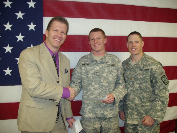 At Utah Valley University in January, Cadet Marcos Heaton, Army ROTC (c), receives an ROTC scholarship award from Maj. Duke Reim, USA, commander, and Martin.